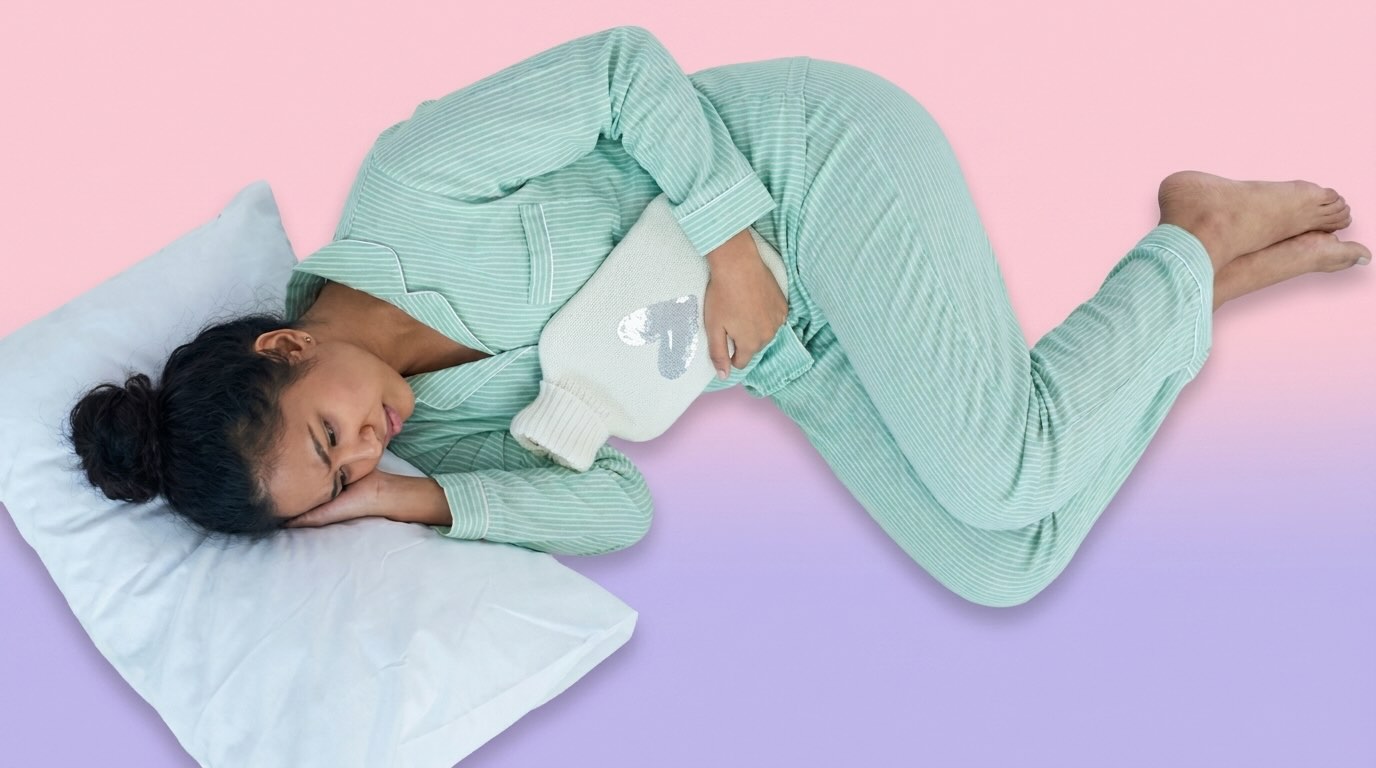 a young woman in bed using heat pad for period